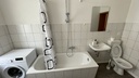 Badezimmer mit Badewanne/Dusche und WC und Waschmaschine