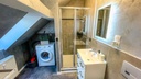 Badezimmer mit Dusche und WC und Waschmaschine